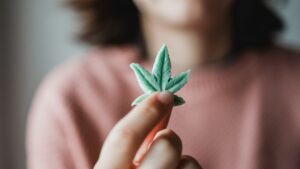 Cbd candy - Woman holding edible cannabis leaf for anxiety treatment - Alternative medicine