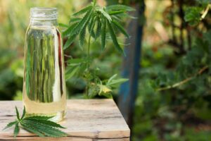 hemp oil in a glass jar with hemp leaf