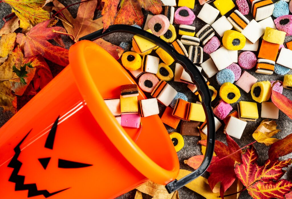 Trick or Treat Pumpkin bucket on side for collecting candy on Halloween